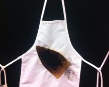 A Battle for Redemption, 2012, iron relief prints, transfer prints on canvas apron, found objects, 28 x 13"