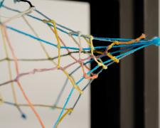 "Black [Peering Through]" (Detail), 2021, embroidery floss, clear cord, matted wood frame, 8 x 4.5 x 6"