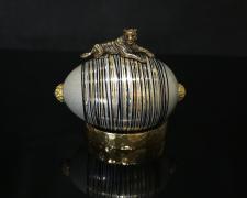 "Big Cat, Small Stripes", 2024, egg, mixed media, 3 1/2 x 4 x 2"