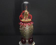 "Big Red Balls", 2024, egg, mixed media, 7 x 3 x 3"