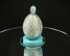 "MiniMod", 2024, egg, mixed media, 2 1/2 x 2 x 2"