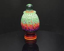 "Quantum Fugue", 2026, egg, mixed media, 4 1/2 x 2 1/2 x 2 1/2"