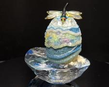 "Soft Landing", 2026, egg, mixed media, 5 x 6 x 4"