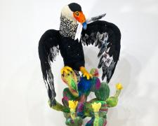 "Courier to The Lamented: The Bird Who Exists Between Worlds", 2025, needle-felted wool and polyfibers, embroidered hand dyed sheet felt, glass beads, secondhand charms on stained wooden base, 40 x 39 x 30"