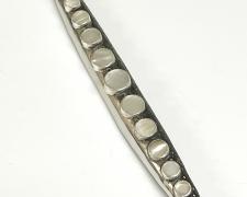 "Piccolo", 2025, brooch: nickel, sterling, fine silver, antique mother-of-pearl buttons, 8 x 1 x 3/4"