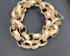 "Say Ahh..." (view 2), 2026, necklace: wooden tongue depressors and zip-ties, 68 x 3 x 2"