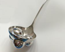 "There's Something or Someone in My Soup", 2025, appropriated and manipulated vintage silver plate ladle, stainless steel, brass, 14 x 4 x 3 1/2"