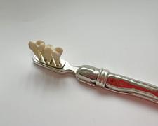 "Toothbrush" (detail), 2025, sterling, nickel, the artist's teeth, 1 x 7 x 1/2"