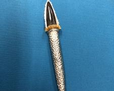 Edward Lane McCartney, "Wand #2", 2019, brooch: repoussed sterling, carved acrylic and micarta, stainless steel, 7 x 1 x 1/2"