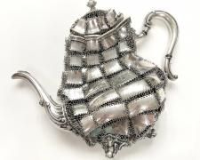 "Heirloom Impotence, Flayed and Flaccid", 2025, silverplate coffee pot, stainless steel, 10 1/2 x 13 x 3 1/2"