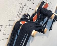 I tried to weave a story too intimate (detail), 2019, torn Astros t-shirt, wooden pegs, 88 x 70"