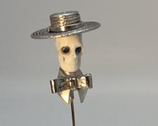 Edward Lane McCartney, "Memento Mori II, Dandy", 2023, stickpin: fabricated sterling, carved bison bone, 14k and 10k yellow gold, vintage foil-backed blue Swarovski crystals