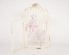 "Caged No. 1" (View 2), 2021, embroidery floss, clear cord, metal bird cage, 6 x 5 x 10.5"