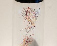 "Specimen No. 1", 2021, embroidery floss, clear cord, corked glass jar, 3 x 3 x 8"