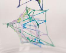 "Specimen No. 2" (Detail 2), 2021, embroidery floss, clear cord, corked glass jar, 3 x 3 x 4.5"