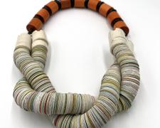 Tarina Frank, "Twisted Stacks (necklace)", 2023, recycled paper, wood, horn, sterling silver, ceramic insulators, 15 x 12 x 2"