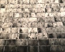 Untitled (Una cancion desesperada) - detail, 2018, asphalt, sand, cement mix, graphite, charcoal, dirt on lint roller sheets, processed by cement mixer, 115 x 179"