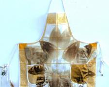 Star Child, 2012, iron relief prints, transfer prints on canvas apron, found objects, 42 x 28 1/2"