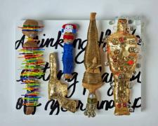 "Eating Playdough", 2023, dolls, paper, adhesive, mixed media, 12 x 16 x 4"