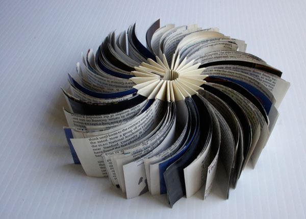 new stage, 2012, reclaimed commercial material inserted into a folded form, 2 x 4" closed / 2 x 8" open
