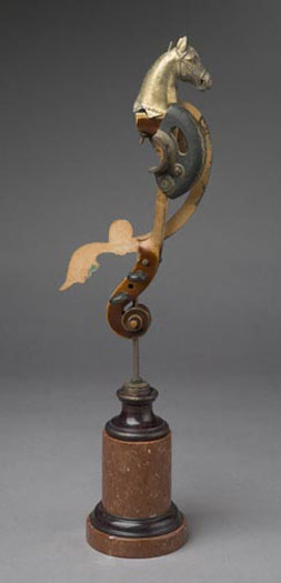 Poseidon's Hippocampus 2007 Assemblage - cast metal horse head, violin neck, sewing machine part, metal disc, decorative wood trim, steel rod, marble base 21 1/4 x 6 5/8 x 4 3/8"